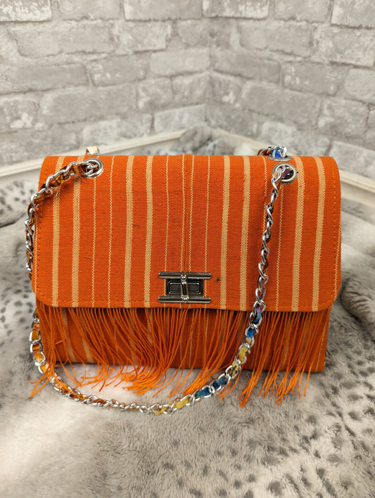 Orange striped fringe handbag