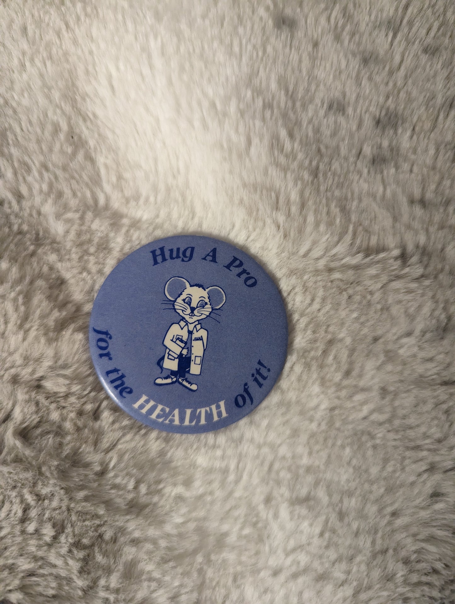 Hug a pro for the health of it Vintage button