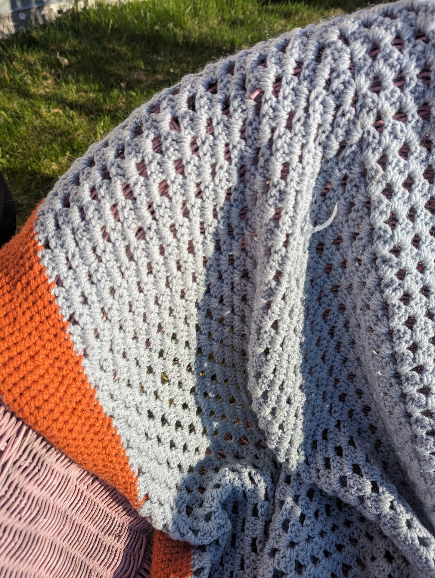 Handknitted grey and orange granny blanket